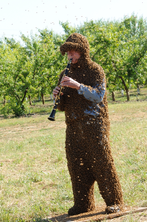 Norm Gary playing B-flat clarinet while wearing his bee suit. (Photo by Kathy Keatley Garvey)