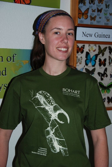 Artist Courtney Lambert wearing the Bohart Museum of Entomology t-shirt. She drew the Western Hercules beetles. (Photo by Fran Keller)