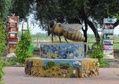 This is the bee sculpture created by artist Donna Billick, co-director and co-founder of the UC Davis Art/Science Fusion Program. The columns of bee hives are the work of the Art/Science Fusion Program. (Photo by Kathy Keatley Garvey)