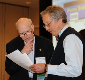 Emcee Tom Turpin (right) of Purdue University confers with judge J. E. McPherson of Southern Illinois University.