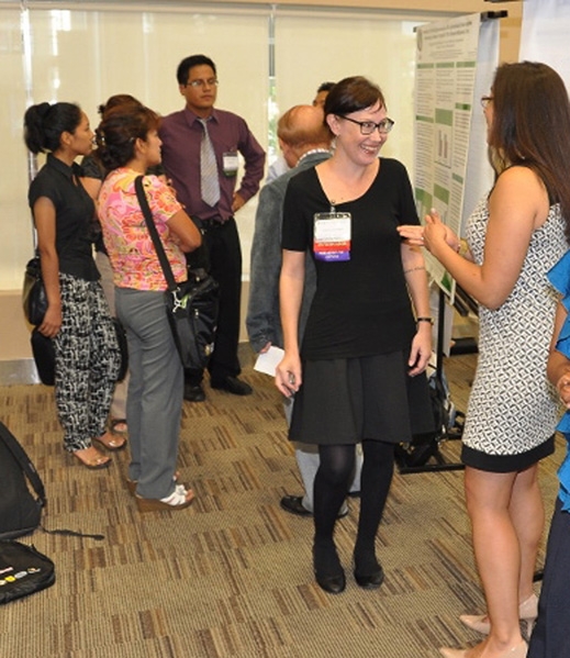 UC Davis dengue researcher Sandy Ohlkowski chats with participants at the fifth annual American Society of Tropical Medicine Hygiene/Peru meeting. She presented her research at the meeting.