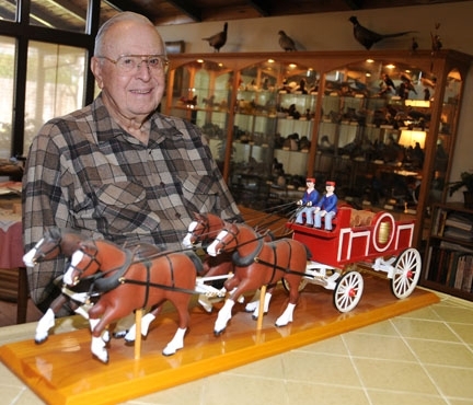 Oscar Bacon with his carving of Clydesdale horses. (Photo by Kathy Keatley Garvey)