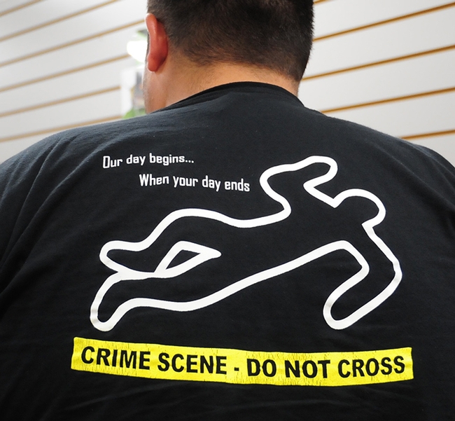 Forensic entomologist Greg Nigoghosian of Purdue drew attention with this T-shirt depicting his occupation.