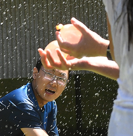 Kai Wang of the international Bruce Hammock lab ducks as he eyes the water balloons. He is a graduate student from China. (Photo by Kathy Keatley Garvey)