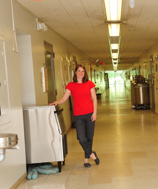 Amy Rand stands in the hallway near her office in Everson Hall. She joined the Bruce Hammock lab in 2013. (Photo by Kathy Keatley Garvey)