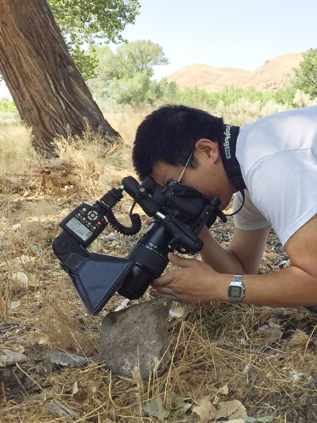 Entomologist/photographer Alexander Nguyen photographing an insect. (Photo by Joel Hernandez)