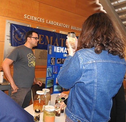 Nematologist and graduate student Christopher Pagan talks to the crowd at the nematology display at the 2017 Biodiversity Museum Day. (Photo by Kathy Keatley Garvey)