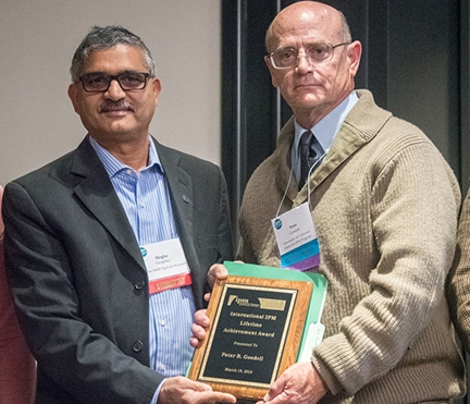 Pete Goodell receives his lifetime achievement award plaque from Megha N. Parajulee, Texas A&M AgriLife Research. (Photo by Lena McBean, Remsberg Inc.)