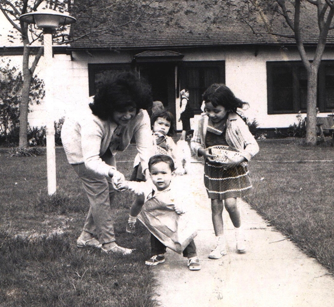 In this childhood photo, mother Lilia Galvan holds her daughter, Elvira. Elvira's siblings Virginia 