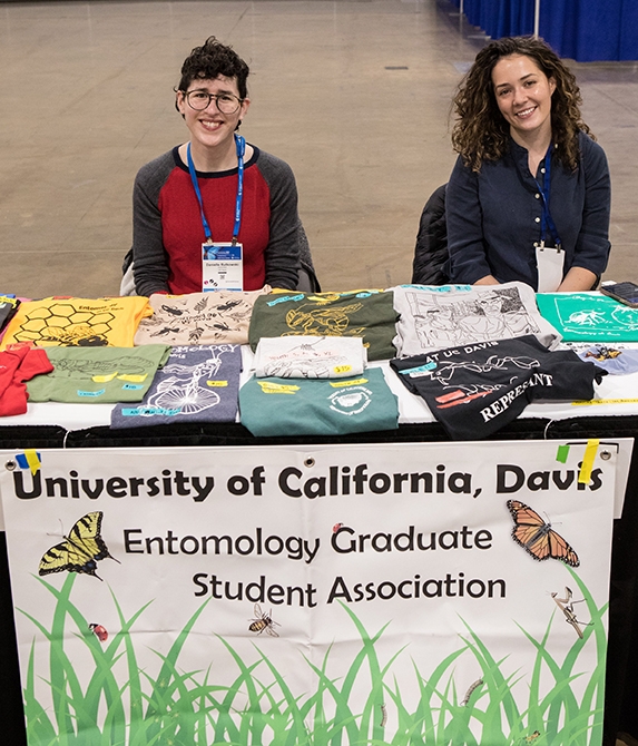 UC Davis doctoral candidates Danielle Rutkowski (left) and Erin Taylor Kelly offering Entomology Graduate Student Association (EGSA) t-shirts at the ESA meeting. Kelly, whose major professor is Geoffrey Attardo, gave a presentation on 