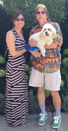 The family: Mike and Grace with their dog, Murphy, a Coton de Tulear.  Murphy passed in April 2020.