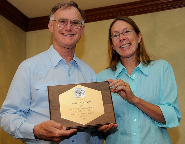 Eric Mussen presenting an award to bee breeder-geneticist Susan Cobey at a Western Apicultural Society meeting. (Photo by Kathy Keatley Garvey)