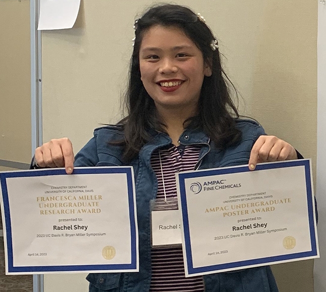 Rachel Shey with her two awards from the R. Bryan Miller Symposium, held recently in the UC Davis Conference Center.