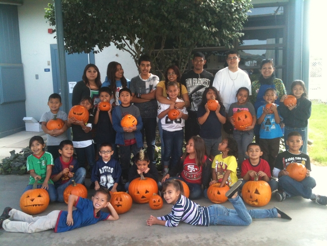 UC nutrition educator Grilda Gomez, back row far right, poses with the students and their jack-o-lanterns.