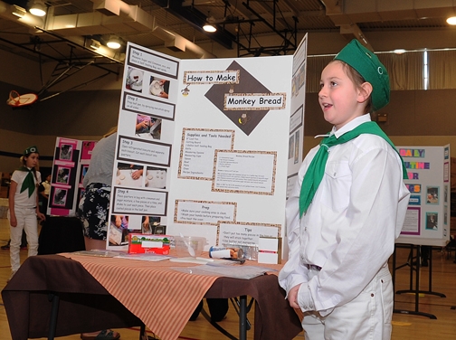 Second-year 4-H'er Maya Farris, 9, of Vacaville, answers questions about her monkey bread display at the Solano County 4-H Presentation Day. (Photo by Kathy Keatley Garvey)