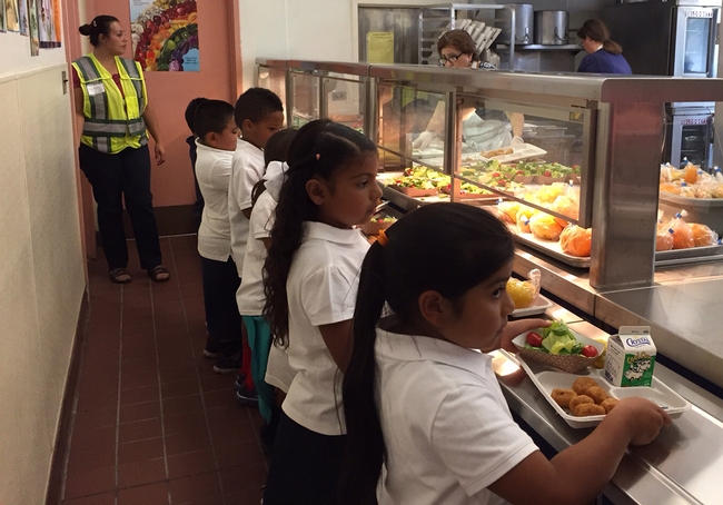 Students serve themselves in Ygnacio Valley Elementary School's new serving line. When the children select their own food, less food gets thrown away.