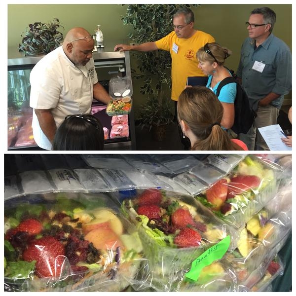 RUSD's Chef Ryan shows visitors his summer salad made fresh from local produce.