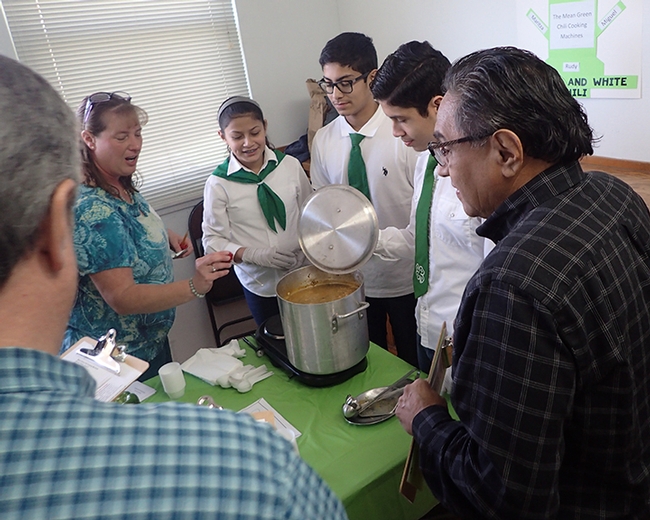 Chili Cook-Off Cooordinator Connie Reed (far left) of the Sherwood Forest 4-H Club, Vallejo,  tests the temperature of the chili. From left are the Mean Green Chili Cooking Machines of the Dixon Ridge 4-H Club: Maritiza Partida Cisneros, Rudy Cisneros Radillo and Miguel Partida Cisneros. At far right is evaluator Solano County Supervisor John Vasquez Jr. (Photo by Kathy Keatley Garvey)
