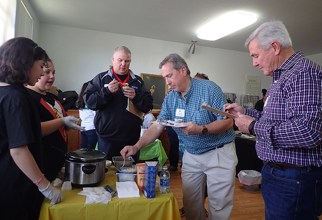 Isabel Martinez (left) and Trinity Roach of the Tremont 4-H Club watch as judges sample their chili. From left are Robert Reed of Benicia, Will Cant of Vallejo, and Solano County Board of Supervisor Skip Thomson of Dixon. (Photo by Kathy Keatley Garvey)