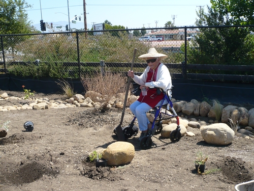 A resident enjoys a 'dry stream bed' in the Veteran's Home Garden.