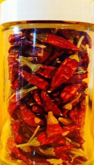 Dried chili peppers stored in a glass jar