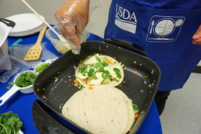 Adding green vegetables to quesadilla is a way to add nutrition to traditional staples.