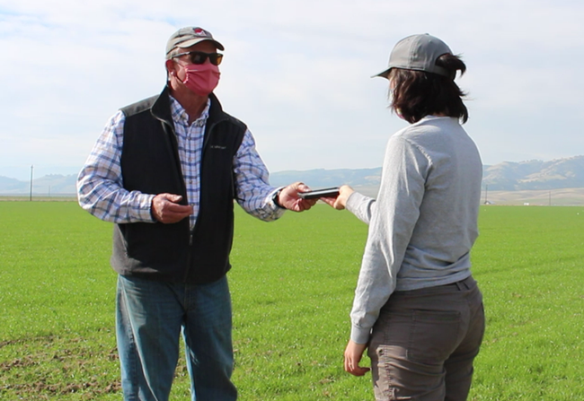 UC Davis researcher Taylor Nelsen shares information with wheat grower Fritz Durst