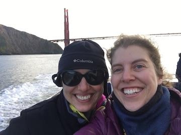 Alda Pires and Beatriz Martinez Lopez shown from the neck down with the Golden Gate Bridge in the background.