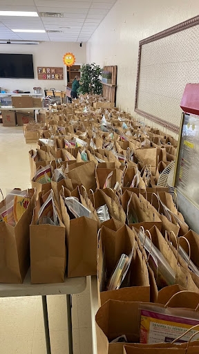 A classroom filled with brown paper bags containing teaching materials for preschoolers