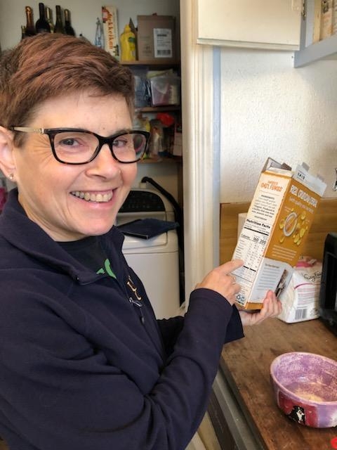 Elaine Silver points to nutrition information on a box of cereal.