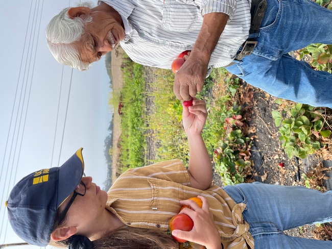 Kirsten Pearsons talks with a farmer in a field