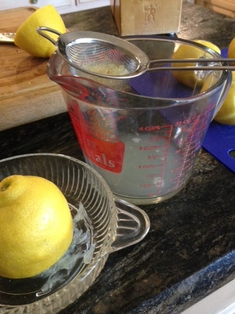 Straining and measuring fresh squeezed lemon juice