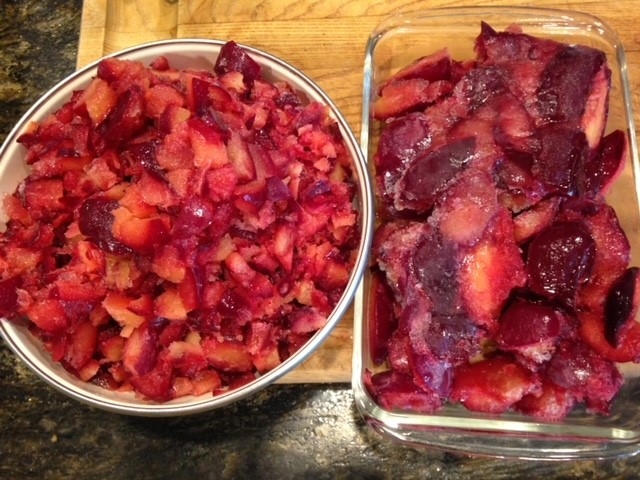 Container of chopped frozen plums and container of frozen plum halves