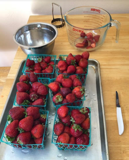Washed and cut strawberries ready to make jam