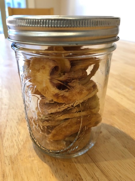 Small glass jar filled with dried apple rings