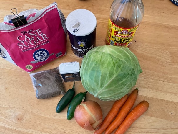 Ingredients needed for the coleslaw arranged on a workspace.
