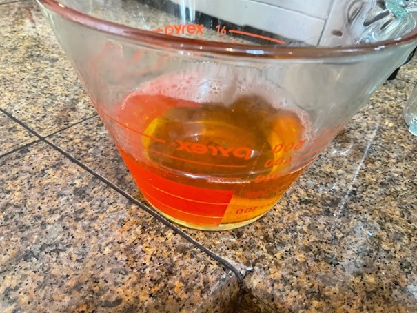 Apple Cider Vinegar in a glass measuring cup.