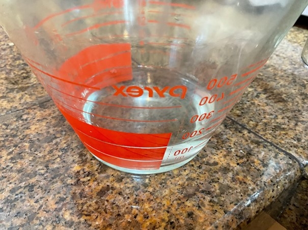Water in a glass measuring cup.
