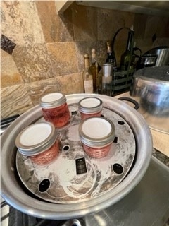 Filled jars in steam canner