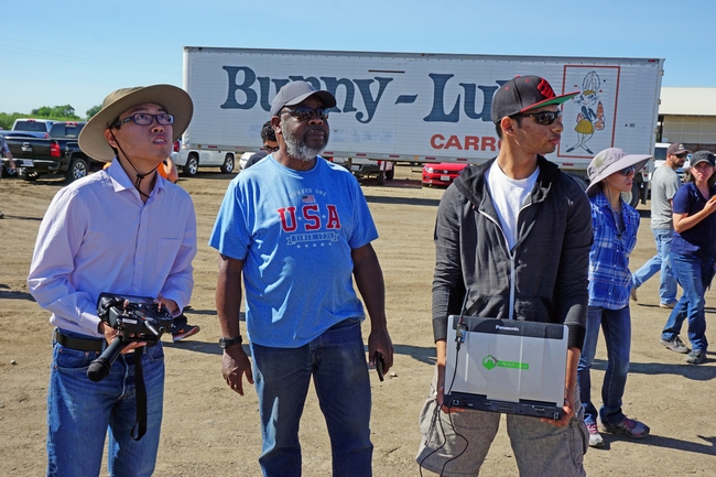 UC Merced graduate students Michael Haoyu, left, and Joshua Ahmed, right, demonstrated the drone they use to gather data over farms. In the center is retired PCA Richard Stewart, who is considering starting a consultancy using drones to monitor for rodent damage.