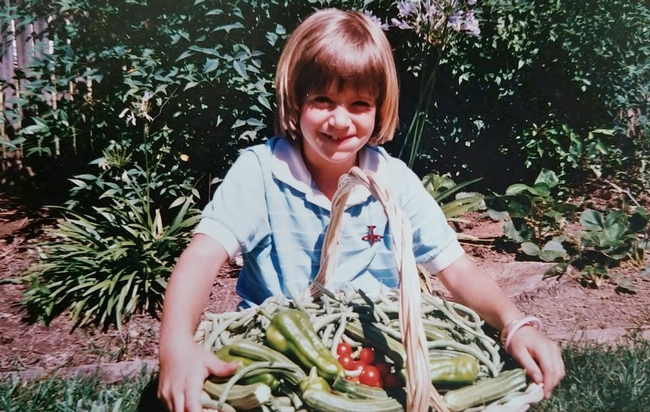 Statewide Training Coordinator Lauren Snowden showing off the summer harvest circa 1987