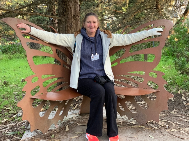 Hafner sitting on a monarch butterfly bench