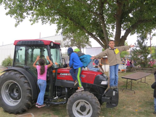 Youths Playing on Tractor Waiting to Start