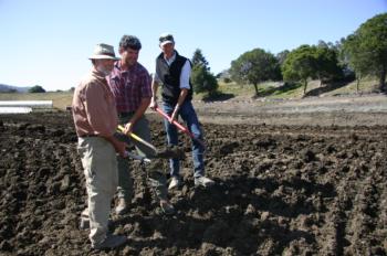 Farmers Dennis Dierks, Peter Martinelli, and Warren Weber with shovels in hand to commemorate the Pine Gulch Project ground breaking