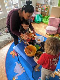 Family Child Care Home provider and child with meal
