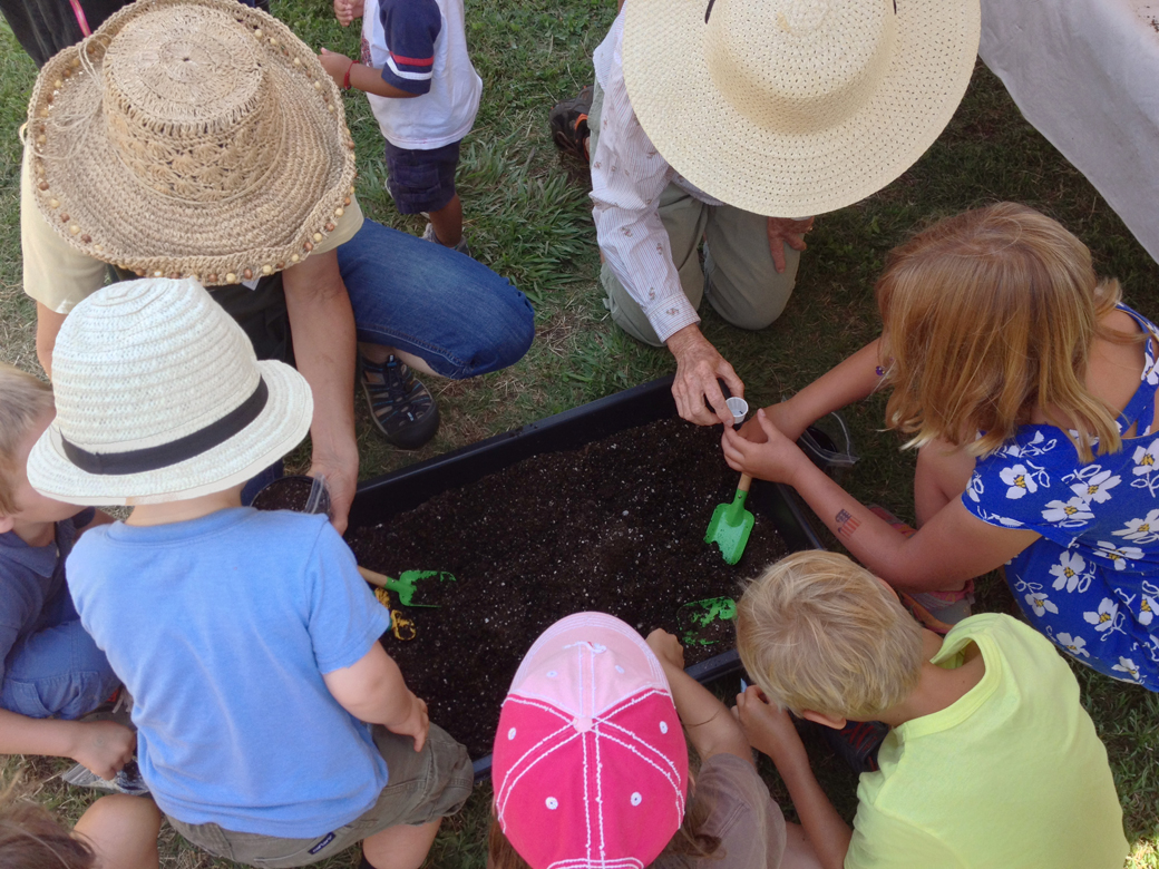 Planting seeds — the kid-sized garden tools are so much fun!