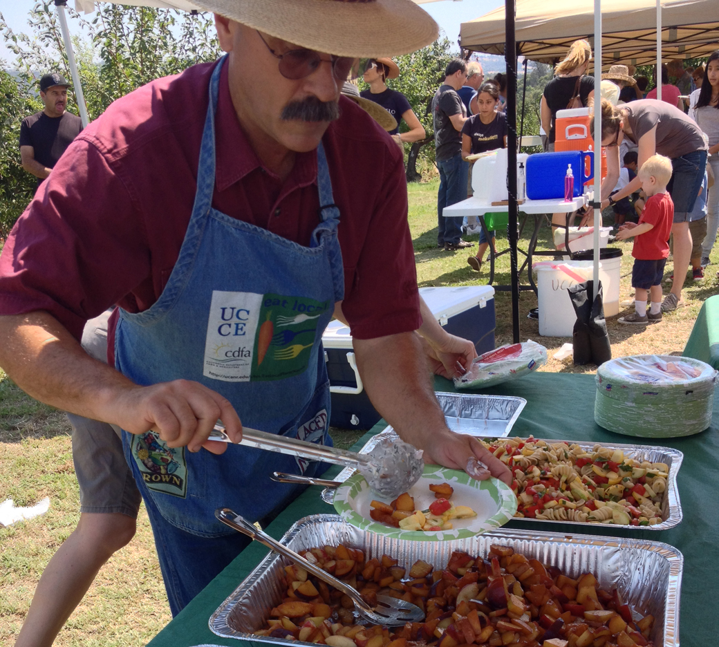 Delicious cucumber salad, mixed seasonal fruit, and zucchini-tomato pasta salad, served up by local farmer Dan Macon!