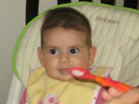 Infant girl eating