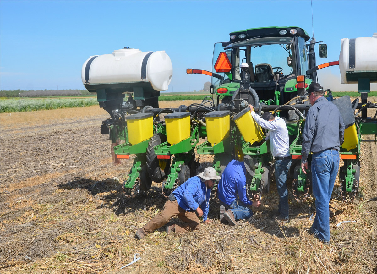 Research colleagues from California Ag Solutions, Madera, Calif., assist with John Deere 1730 no-tillage planter adjustments for garbanzo seeding. Photo: Jeffrey P. Mitchell.