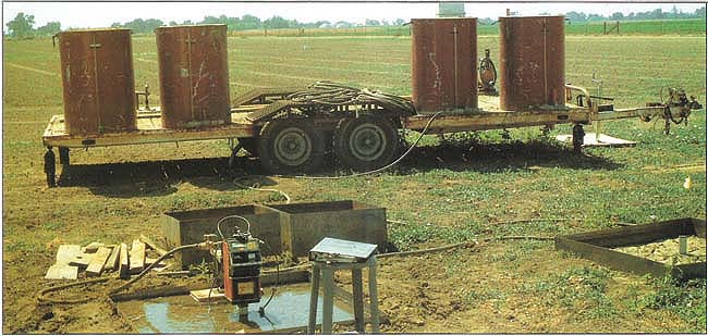 Low-sodium and sodium-added irrigation waters were stored at the test site and applied to small experimental plots. The neutron probe (foreground) measured the presence of water at various depths during first and second wettings for each water type.